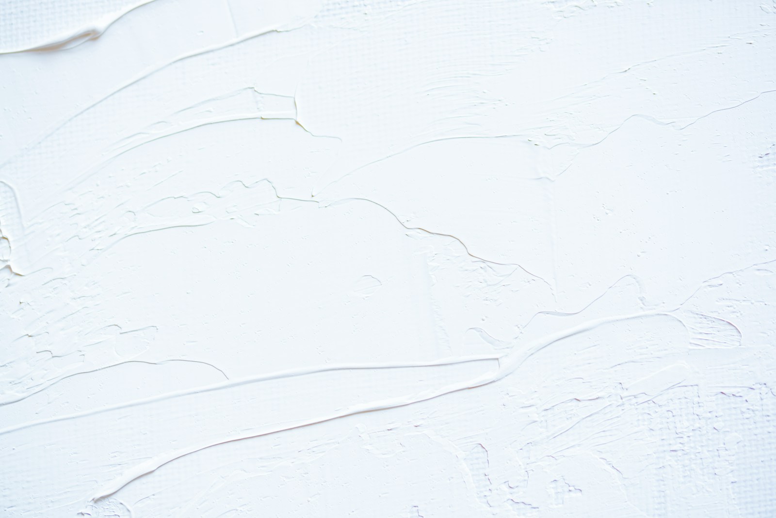 a close up of a white wall with peeling paint